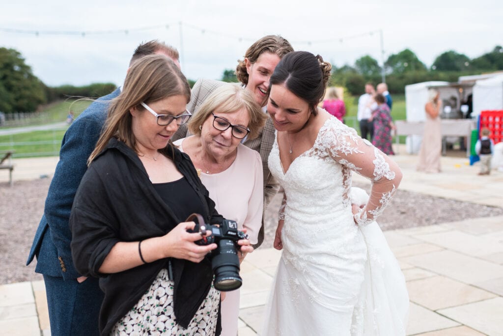 Amy, our second photographer, sharing an image with a bride and mother of the bride