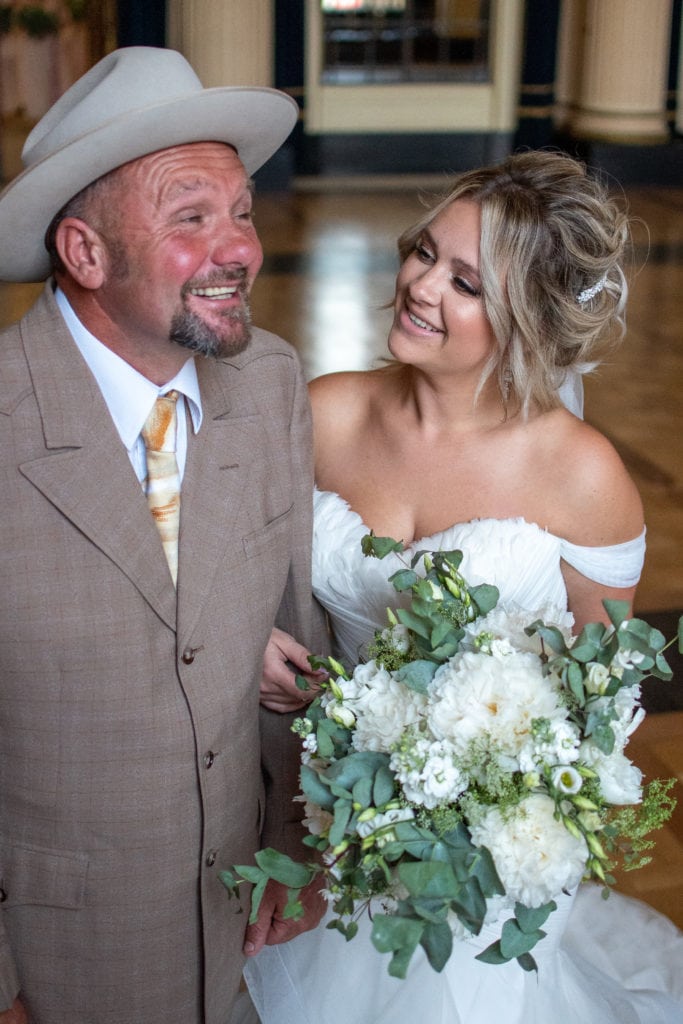 Father of the bride and bride having a giggle