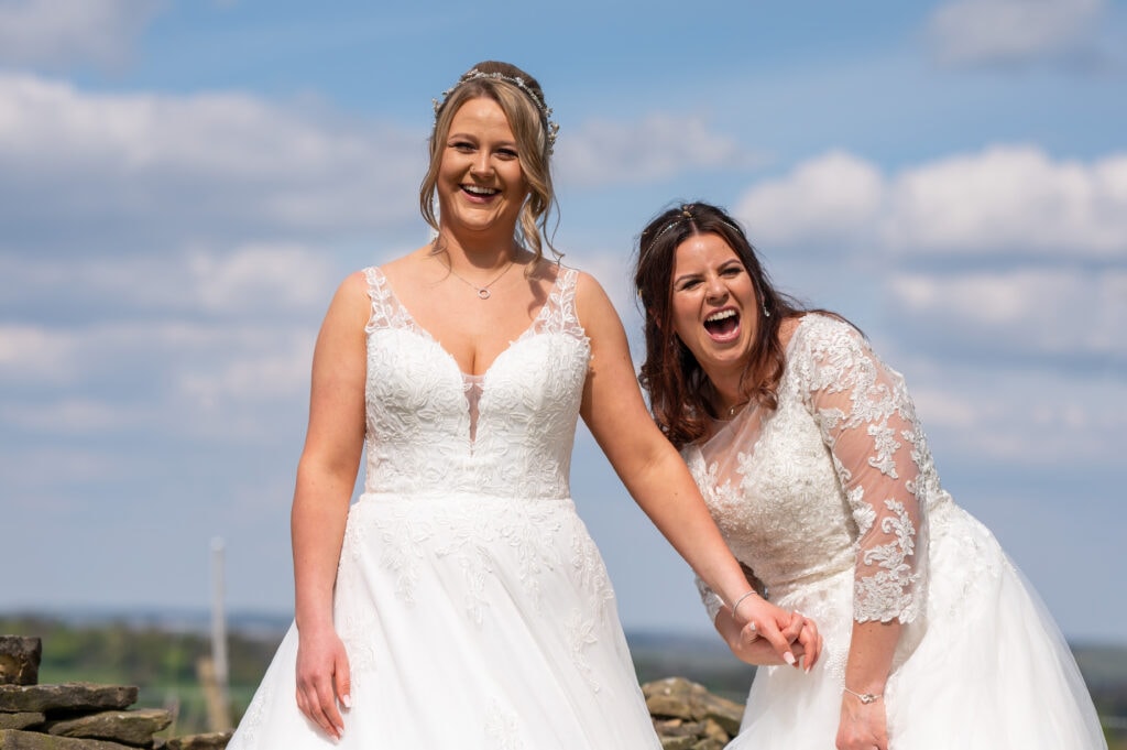 Two brides laughing on their wedding day