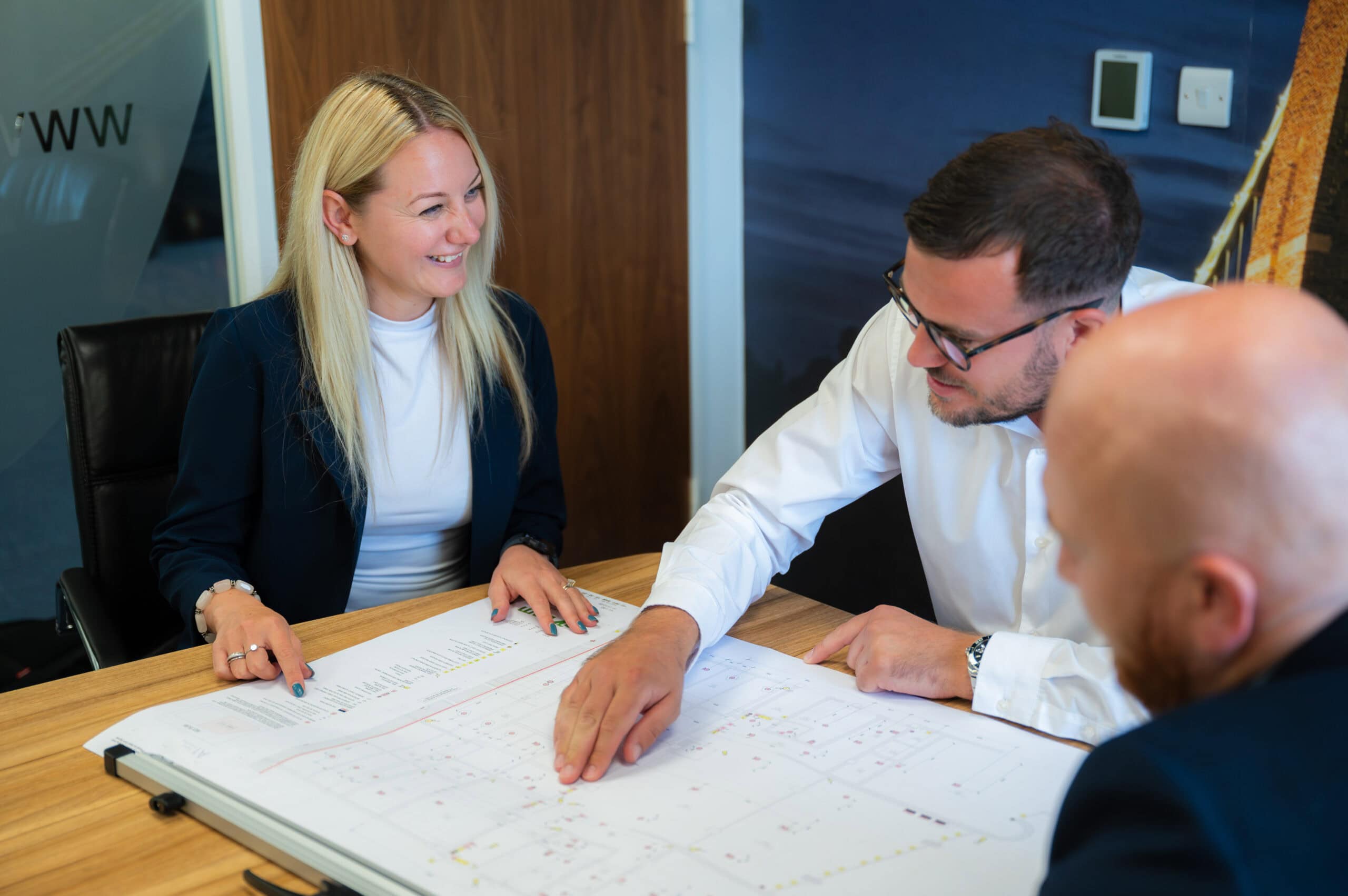 Colleagues meet around a table in the office