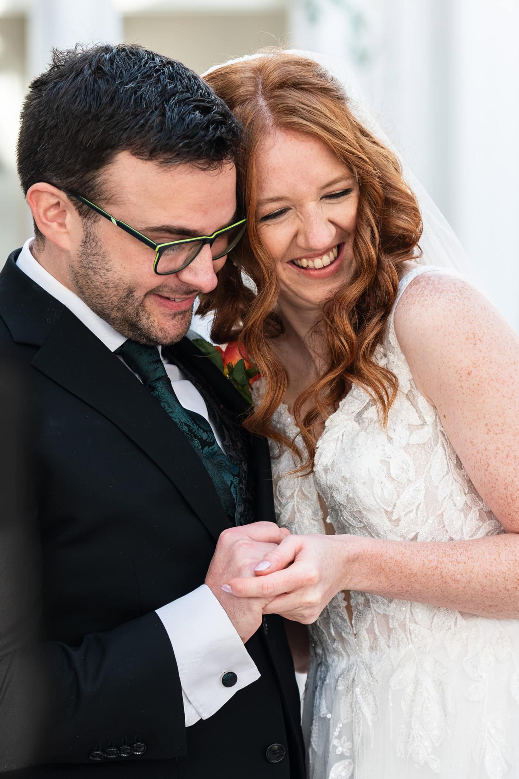 Natural wedding photography of a bride and groom laughing together after their ceremony in Nottingham