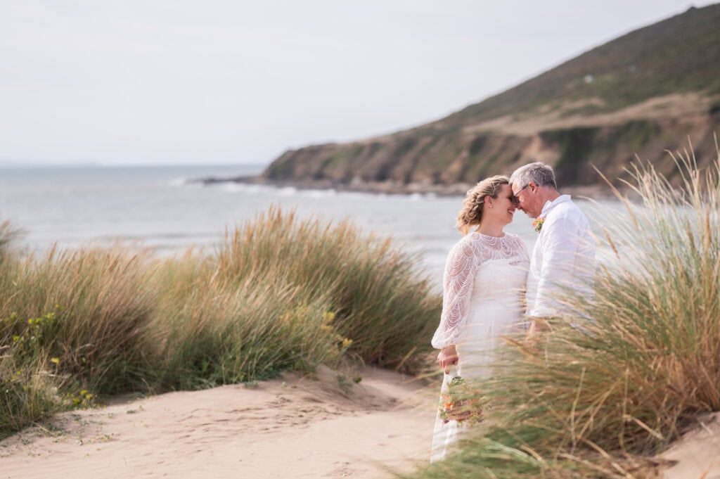 Romantic wedding portrait of a bride and groom among coastal sand dunes, photographed by a Nottingham wedding photographer