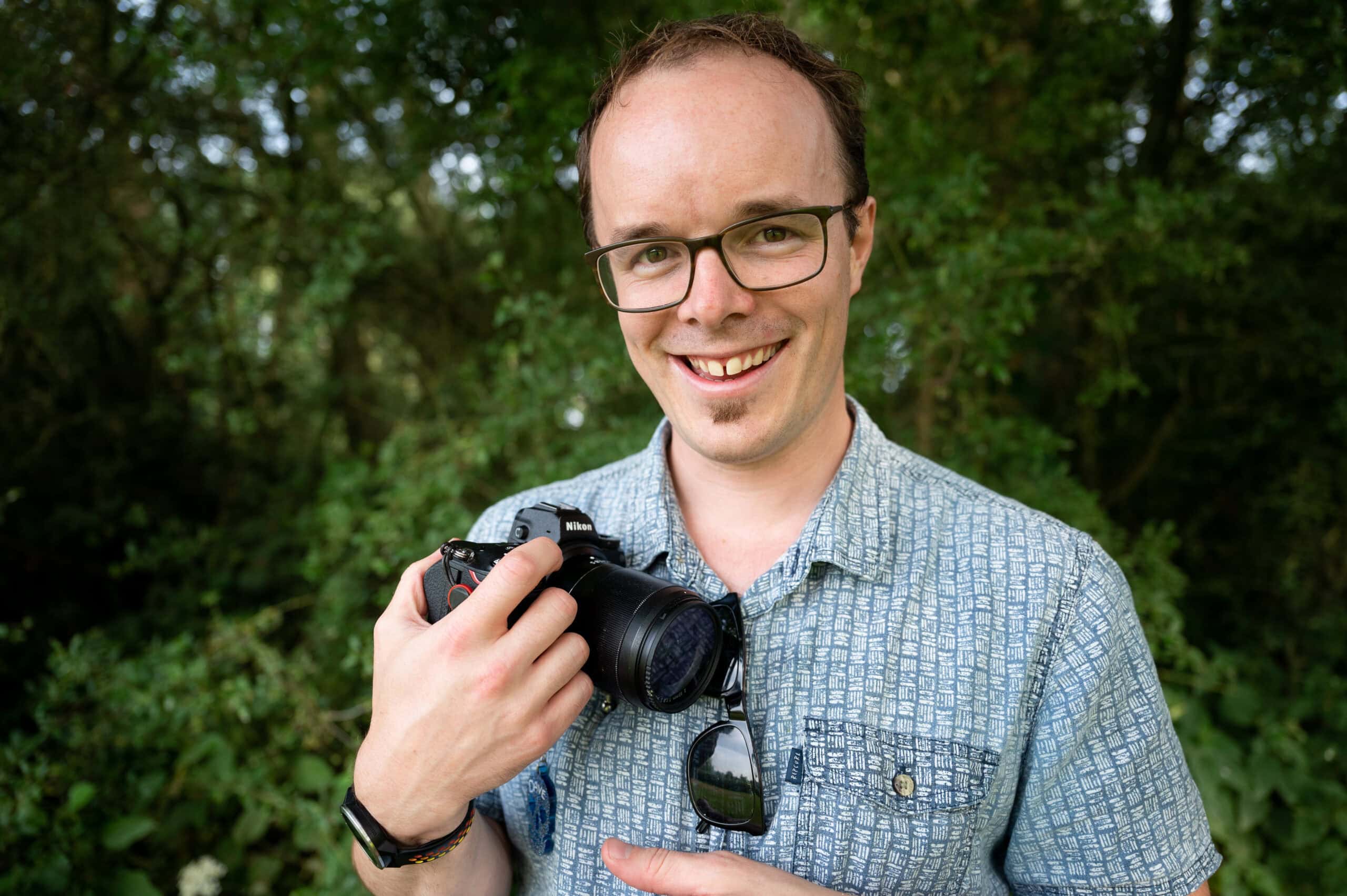 Dave Fuller, Nottingham wedding photographer, smiling with his camera