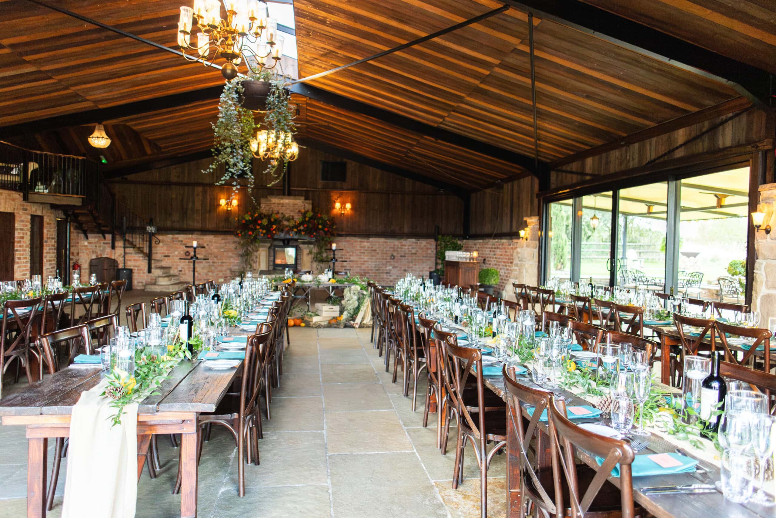 Long tables set for the wedding breakfast in the barn at Willow Marsh Farm