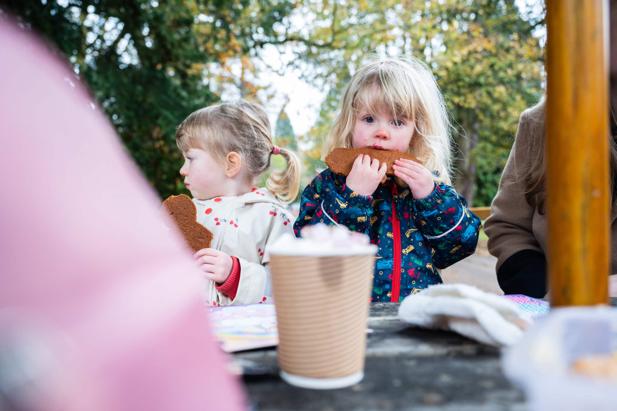 Children enjoy snacks at a picnic table