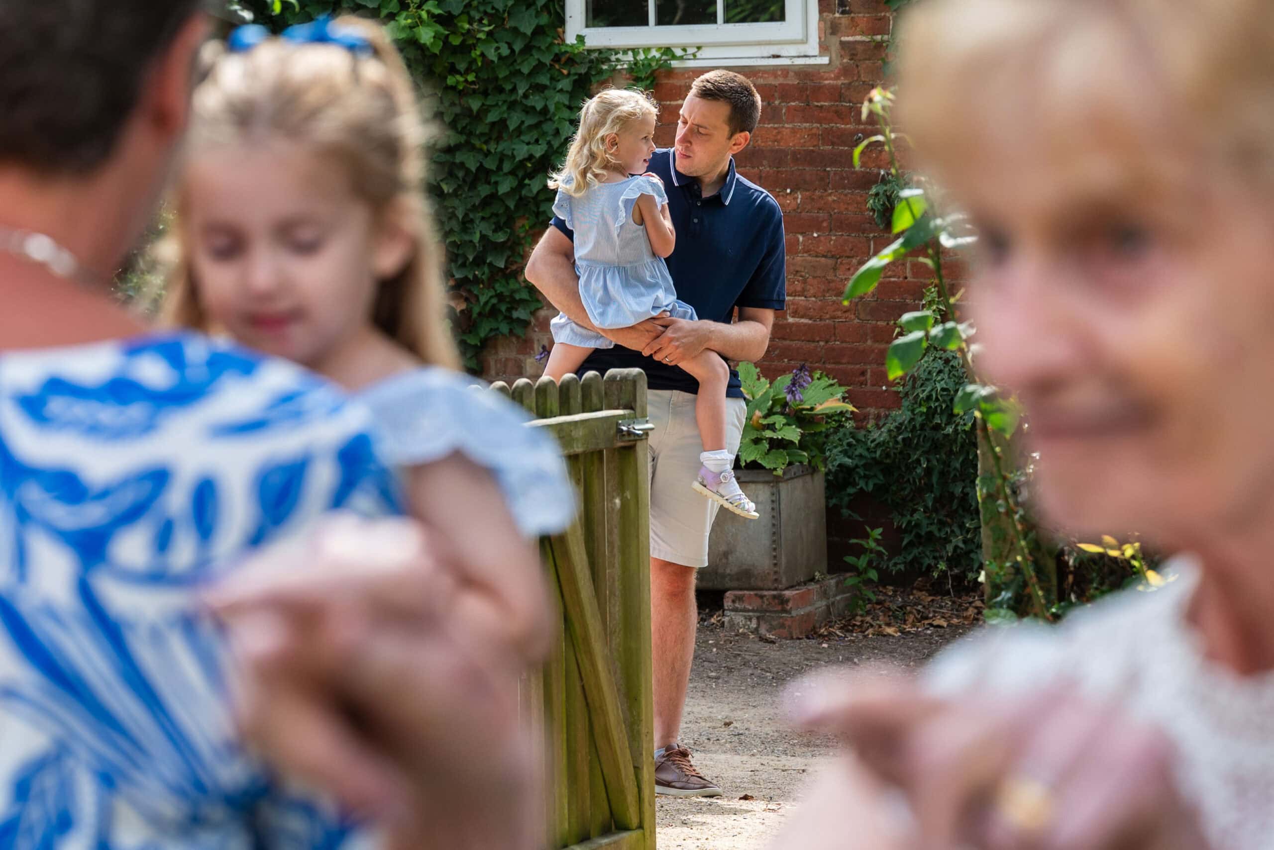 A little girl with her grandma in the garden at a family gathering