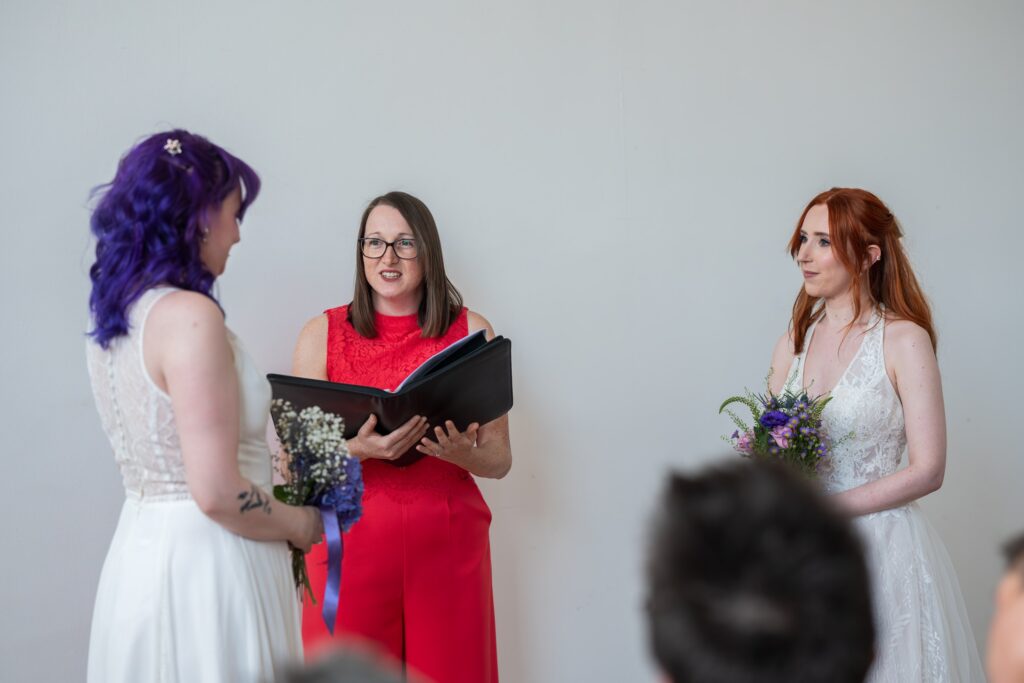 Celebrant from Queer Ceremonies leading Emma and Bea's wedding at Fazeley Studios