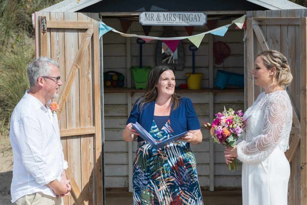Lizzy and Richard's celebrant ceremony in front of a beach hut at Saunton Sands