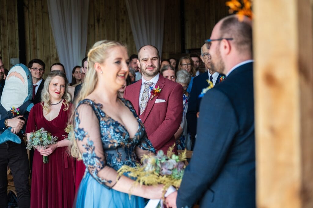 Christine smiling at Paul during their celebrant ceremony in the barn at Sedgewell Barn