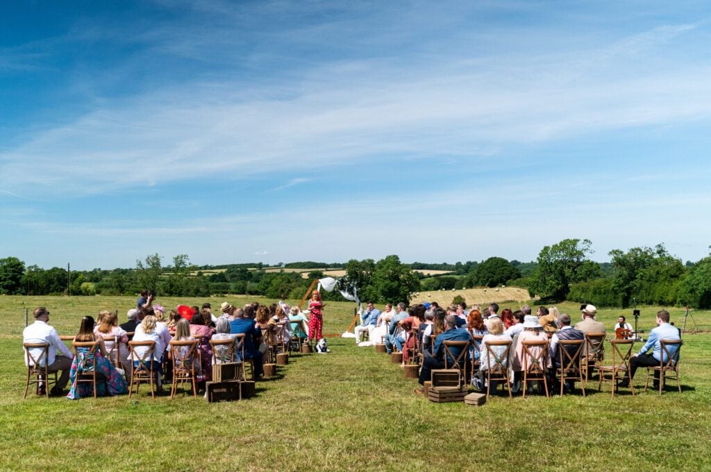 Wide view of an outdoor celebrant wedding ceremony in a field at Stone Siding, Northamptonshire