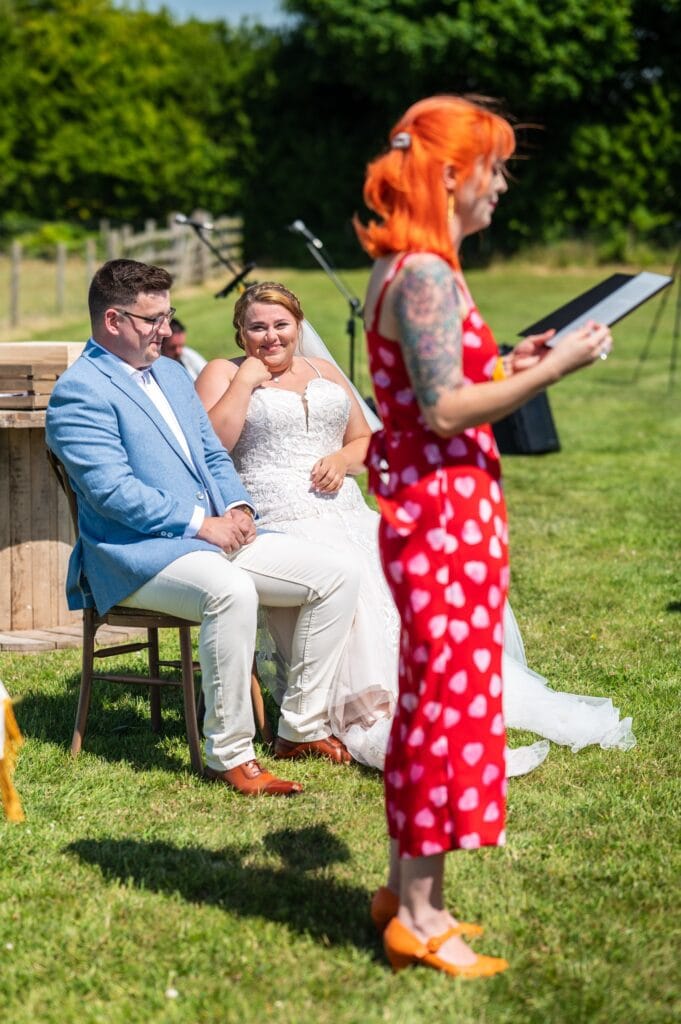 Celebrant Louise from Kickass Gatherings telling a story as Ellie and Edward laugh