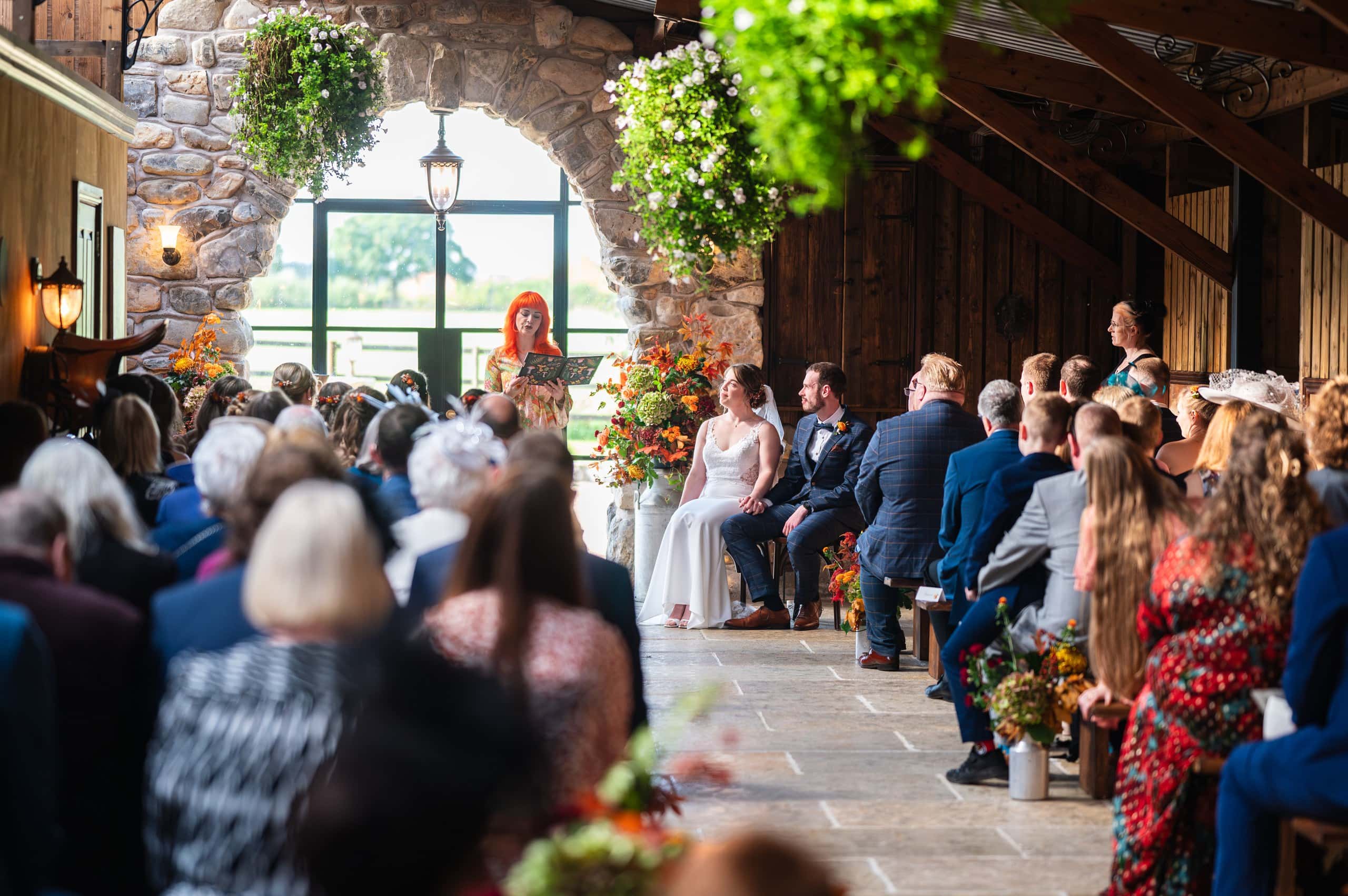 Guests watching a celebrant-led ceremony in the barn at Willow Marsh Farm, East Leake
